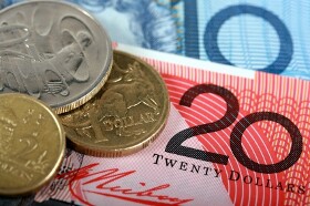 Aussie Edges Down as RBA Cuts Main Rate More Than Expected